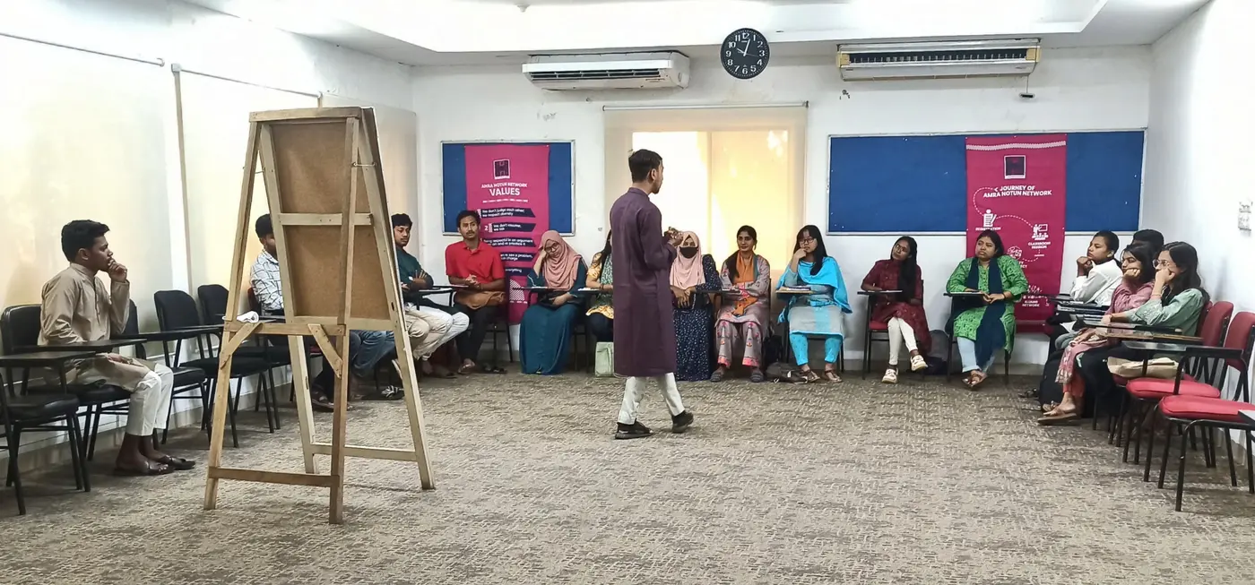 Jobayer speaking to students in a classroom